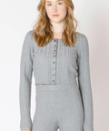 Woman wearing a gray checkered outfit against a white background