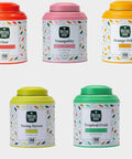 Five tea canisters with colorful lids and labels on a white background
