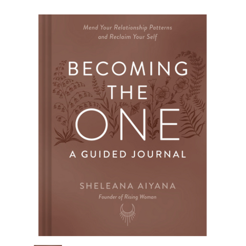 Book titled 'Becoming the One: A Guided Journal' by Sheleana Aiyana on a brown background