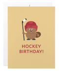 A hockey-themed birthday card featuring a cartoon brown bear wearing a red helmet and holding a hockey stick, with the text 'HOCKEY BIRTHDAY!' printed below on a warm beige background.
