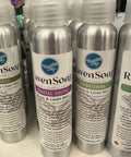 Row of aluminum bottles with labels on a white surface