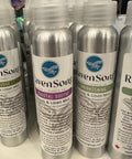 Row of aluminum bottles with labels on a white surface