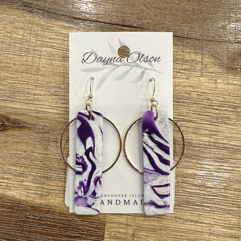 Purple and white marbled hoop earrings on a branded card with 'Dayna Olson' branding.