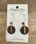 Wooden earrings with gold accents on a 'Dayna Olson' card with 'Vancouver Island Handmade' text, on a wooden surface.