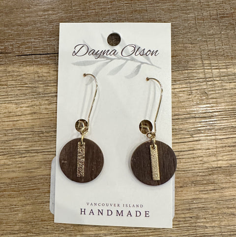 Wooden earrings with gold accents on a 'Dayna Olson' card with 'Vancouver Island Handmade' text, on a wooden surface.