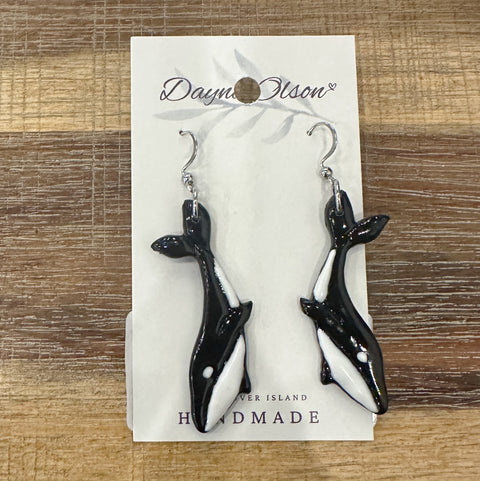 Black and white whale-shaped earrings on a card with 'Dayne Olson' branding.