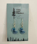Earrings on a Tide and Timber branded card with a tree and wave design.