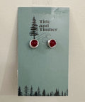 Pair of earrings on a Tide and Timber branded card with a forest design.