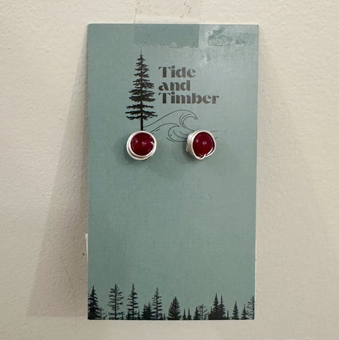 Pair of earrings on a Tide and Timber branded card with a forest design.