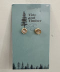 Pair of earrings on a 'Tide and Timber' branded card with a forest design.
