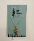 Necklace with a stone pendant on a Tide and Timber branded card