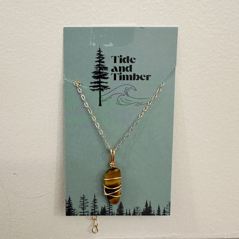 Necklace with a stone pendant on a Tide and Timber branded card