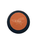 Round makeup product with 'Chai' branding held by a hand against a neutral background
