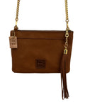 Brown leather clutch with gold chain strap on a light wooden background