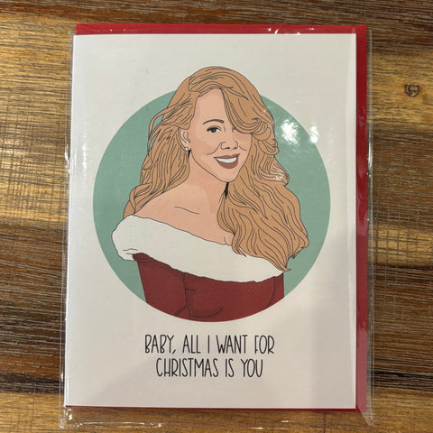 Card with illustration of a woman and text on a wooden surface