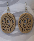 Coast Salish Art Earrings on a branded card with a blurred background