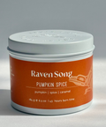 Candle jar labeled 'Raven Song Pumpkin Spice' on a gray background