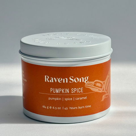 Candle jar labeled 'Raven Song Pumpkin Spice' on a gray background