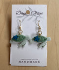 Turtle-shaped earrings on a 'Daya Olson' card with 'Vancouver Island Handmade' text.