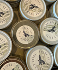 Collection of small containers with 'Every Scent Tells a Story' label.