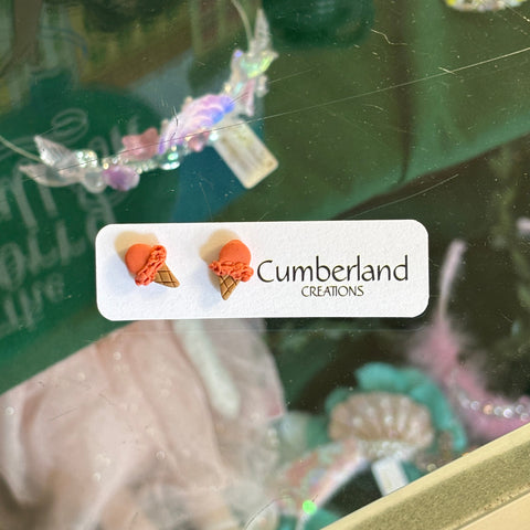 Product packaging with 'Cumberland' branding and decorative elements.