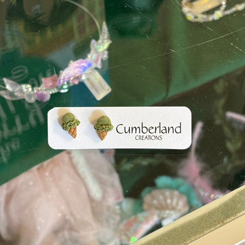 Close-up of a green bottle with a label featuring 'Cumberland' and images of plants.