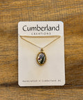 Necklace on a Cumberland Creations card with a wooden background