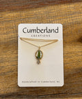 Jewelry card with a necklace on a wooden surface