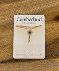Jewelry card with a necklace on a wooden surface