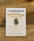 Necklace on a Cumberland Creations card displayed on a wooden surface