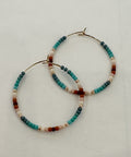 Set of beaded hoop earrings on a light gray background