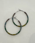 Pair of beaded hoop earrings on a light gray background