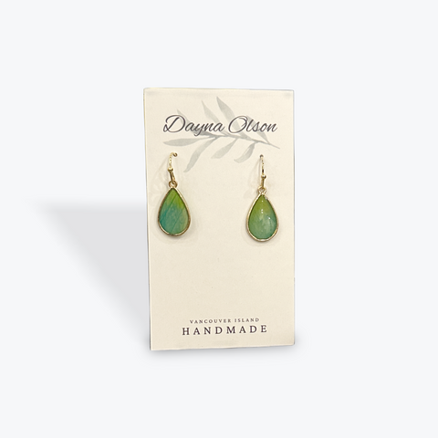 Green teardrop earrings on a card with 'Dayna Otson' branding