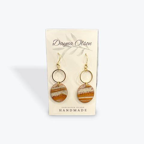 Pair of earrings on a Danya Olson branded card with a white background