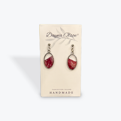 Red earrings on a card with 'Dayna Olsson' branding on a white background