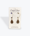 Pair of earrings on a card with 'Dayna Olson' branding on a white background