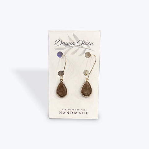Pair of earrings on a card with 'Dayna Olson' branding on a white background