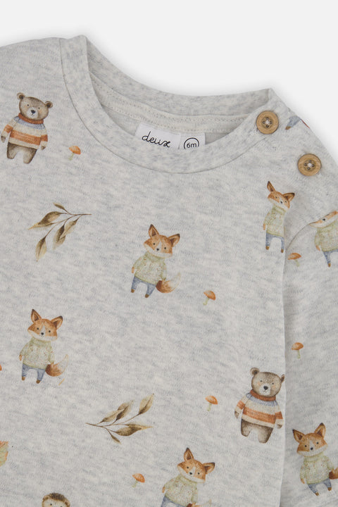 Close-up of the woodland animal print and shoulder buttons on the Deux par Deux baby set.