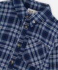 Close-up of the blue and white plaid, collar, buttons and chest pocket on the Deux par Deux shirt.