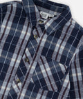 Close-up of the plaid flannel fabric, collar and chest pocket on the Deux par Deux blue and white shirt.