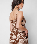 Woman wearing a floral dress with a plain background