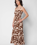 Woman wearing a floral dress on a plain background