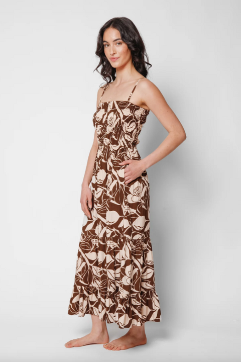 Woman wearing a floral dress on a plain background