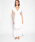 Woman wearing a white dress against a plain background