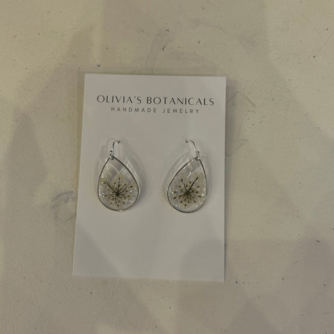 Teardrop-shaped earrings on a card with 'Olivia's Botanicals' branding on a light surface.