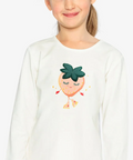 A young girl with blonde hair tied back is wearing a white long-sleeve t-shirt with a cute cartoon strawberry graphic on the front. The image has a light gray background and a small green label in the top right corner that reads 'Coton biologique'.