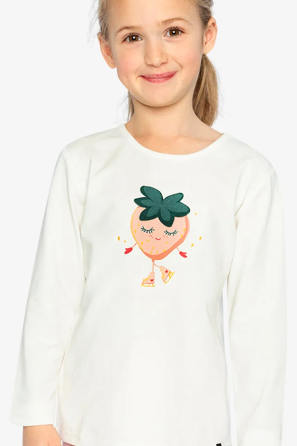 A young girl with blonde hair tied back is wearing a white long-sleeve t-shirt with a cute cartoon strawberry graphic on the front. The image has a light gray background and a small green label in the top right corner that reads 'Coton biologique'.