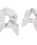 Two marble-patterned scrunchies on a white background
