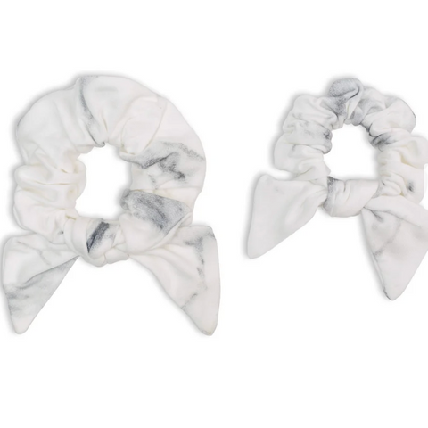 Two marble-patterned scrunchies on a white background