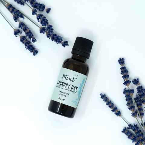 Essential oil bottle labeled 'Laundry Day' with lavender flowers on a white background